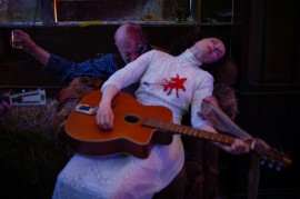 Meret collapses drunk in the Bar Of The Afterlife on a cowboy played by musician Bob Rutman.//Photography by Ralf Schmerberg